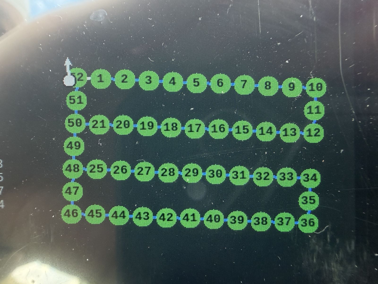 A base-station screen in sunlight showing 52 numbered green waypoints joined in a four-row serpentine pattern.